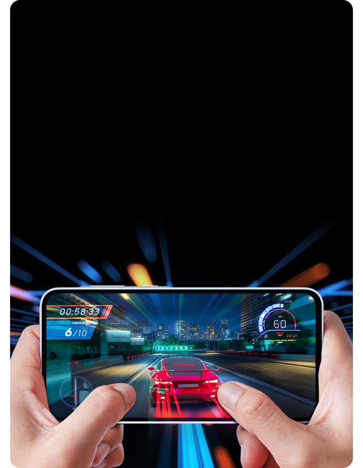 First-person view of a racing game being played on a smartphone held in two hands. The game displays a red sports car speeding on a city highway at night.