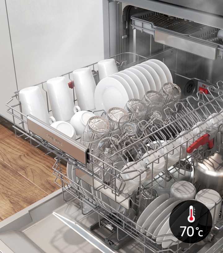 Shows a dishwasher full of plates, cups and glasses that have been rinsed at 70˚C to kill off 99.999% of bacteria.