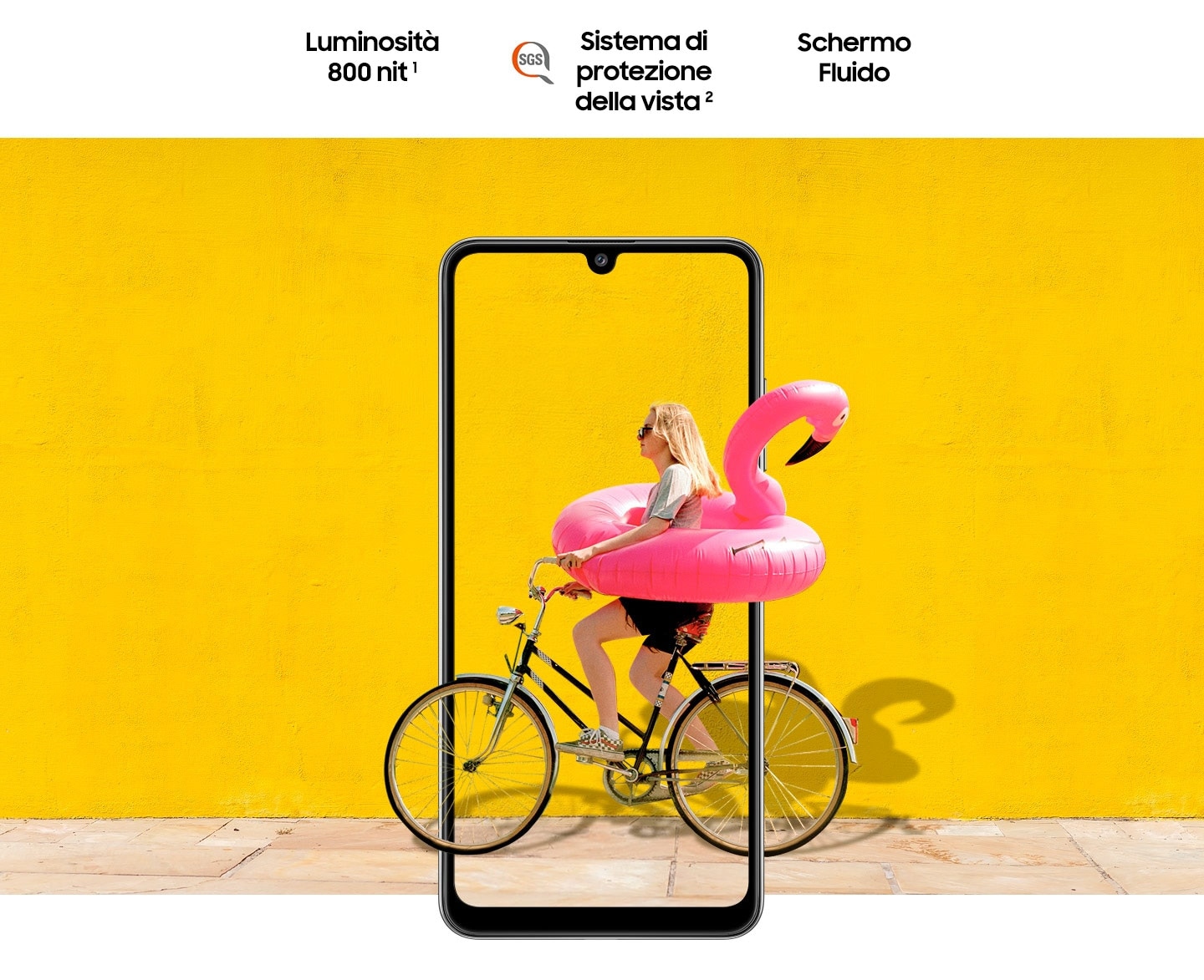 A woman on bike behind Galaxy A32. The picture goes the phone display's edges to represent its immersive view. Text says Brightness 800 nits, Eye Comfort Shield, with the SGS logo and Real Smooth.