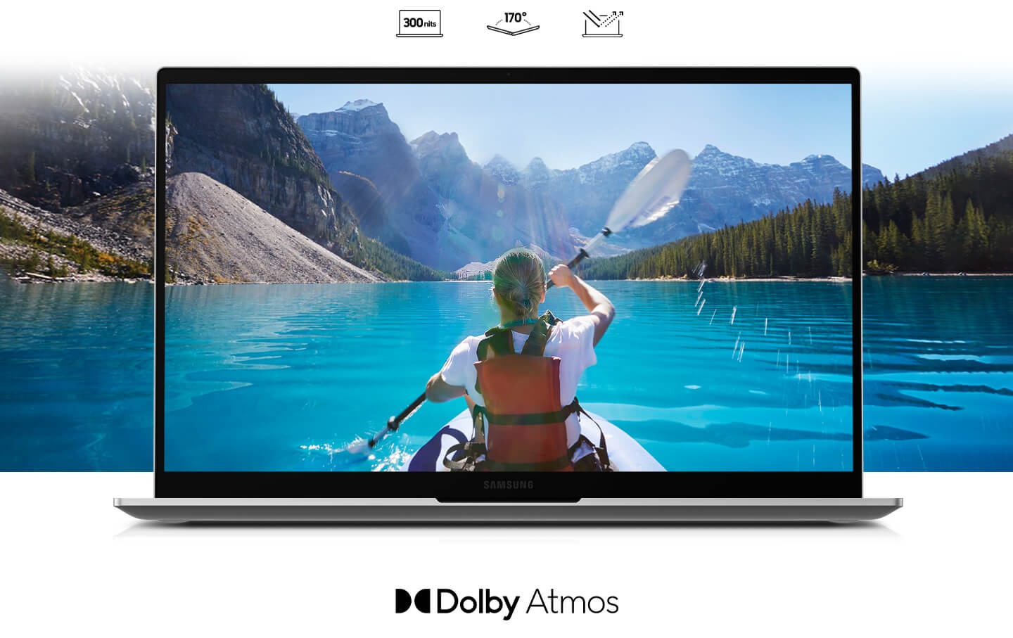 A girl with a ponytail riding in a canoe, paddles the river surrounded by mountains. The extensive river and mountain view are applied on both inside and outside of the laptop display. Dolby Atmos logo written at the bottom.