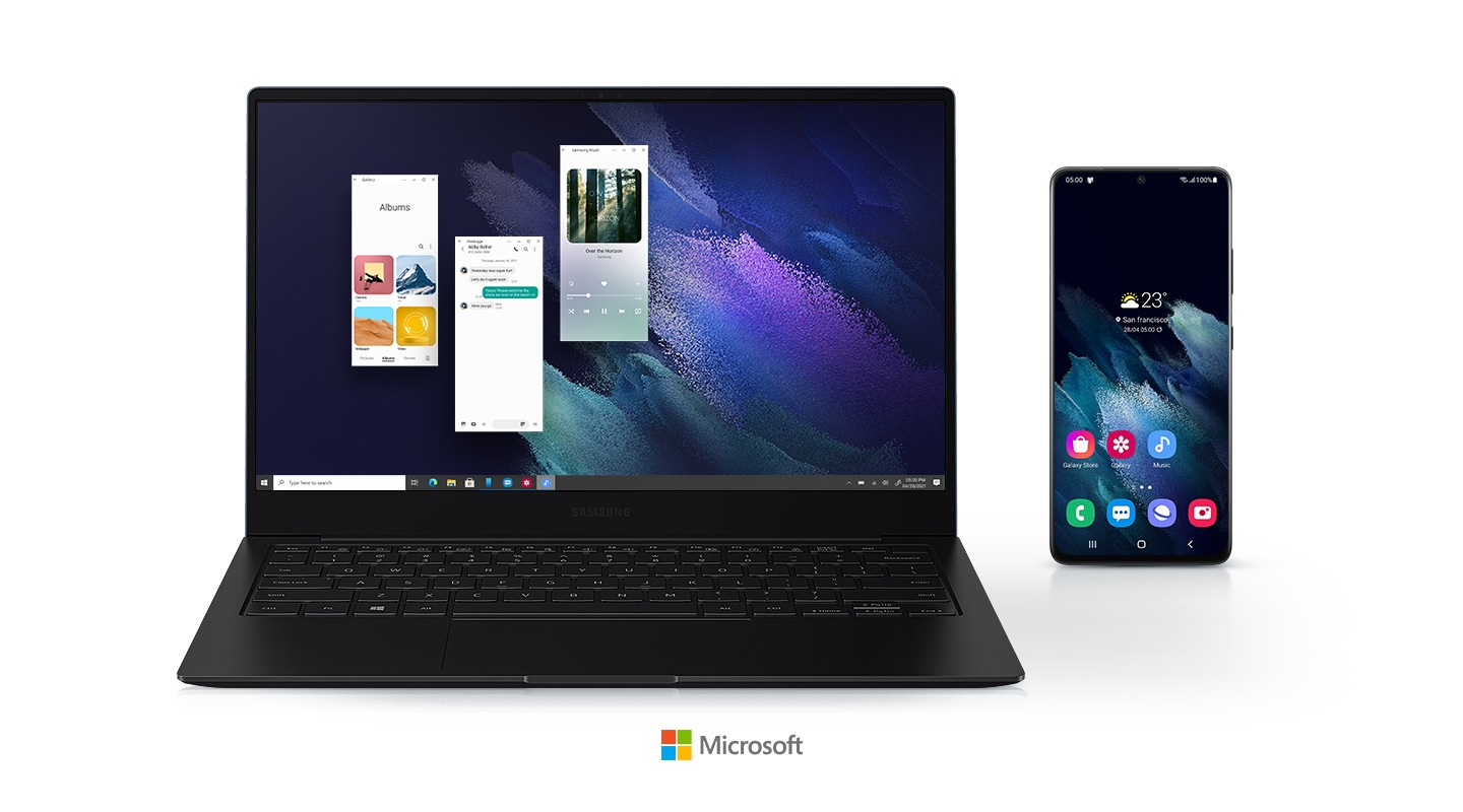 Three Android apps are being run on the Galaxy Book Pro by using Your Phone app. A mobile phone is displayed right next to the laptop, showing that the two devices are connected. A logo of Microsoft is placed below the devices.