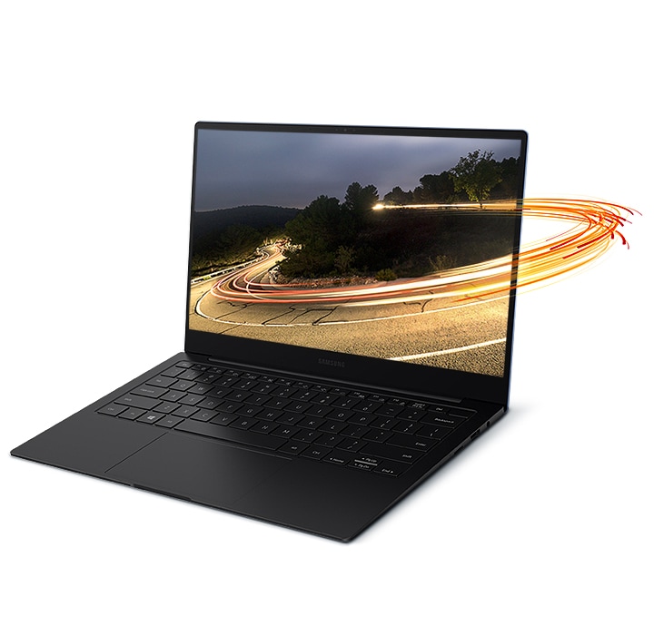 Light swirls encircle a laptop screen, encompassing a photo of a mountain road displayed on the screen of Galaxy Book Pro.