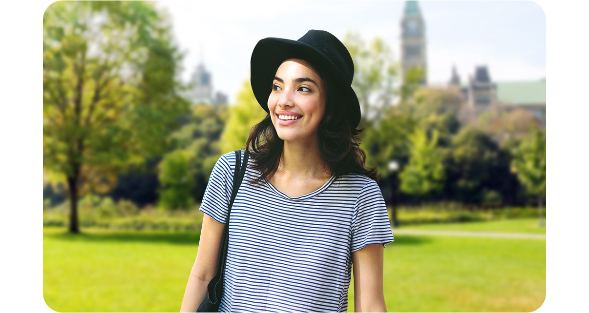 A woman is in the park where lots of trees as a background seem blurred with the depth camera..