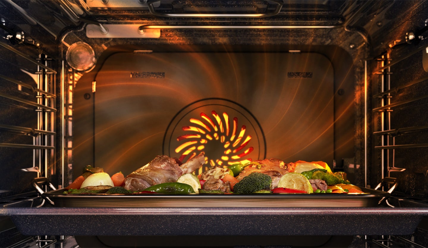 Shows a meal being cooked inside the oven with a heated fan at the back spreading heat evenly all around the oven.