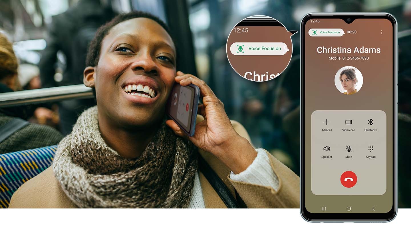 A woman on a bus, smiling, is taking a call with her M23 5G device. On the right is a Galaxy M23 5G device shows that the call is with Christina Adams. A zoom-in bubble placed at the top left of the screen reads Voice Focus on in green text to show that the feature is activated.