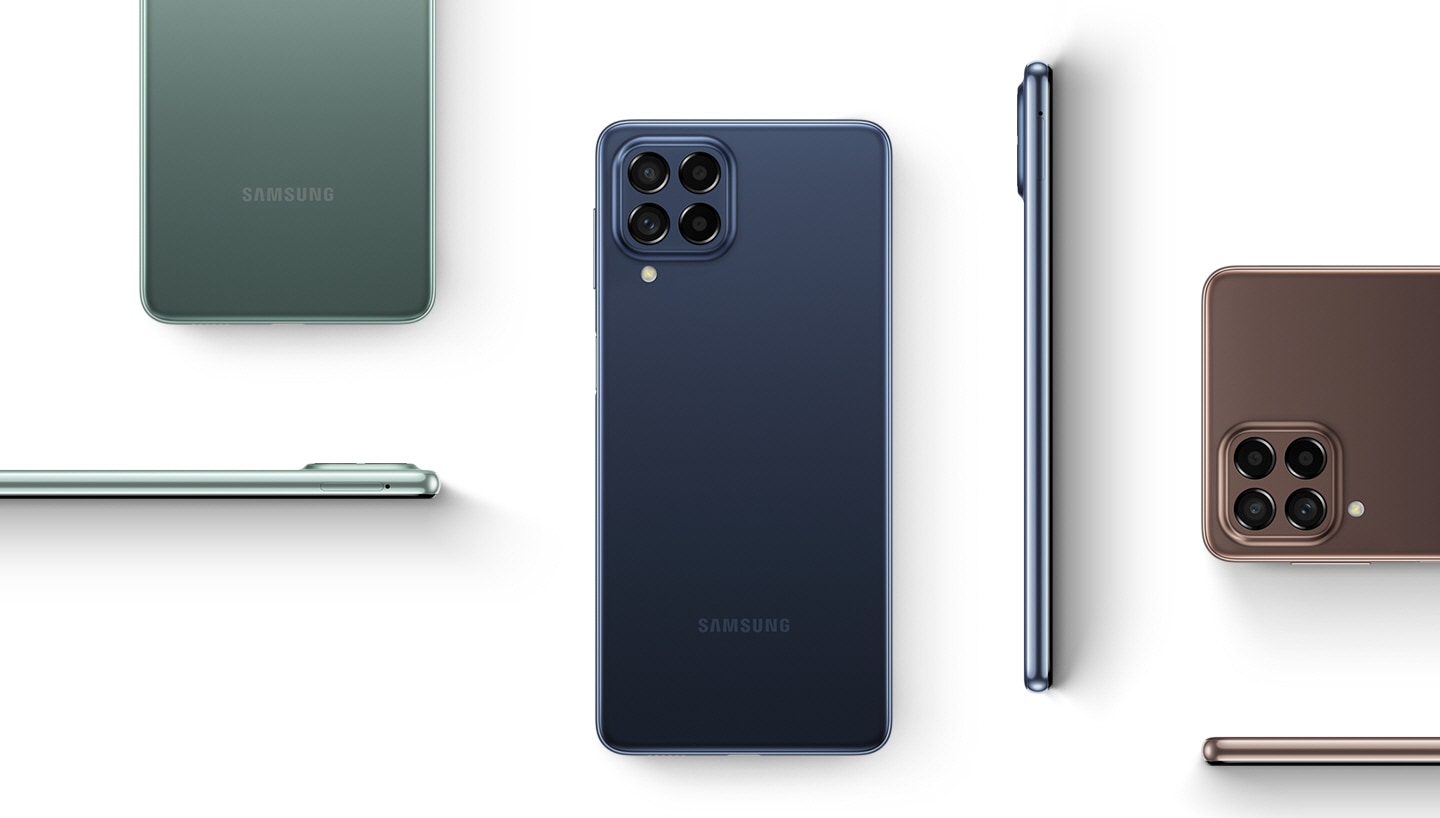 Various Galaxy M53 5G devices are placed in different positions to show the device from the back and the side. The devices are in Blue, Green and Brown colorways.
