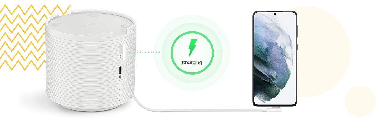 A smartphone is charging with The Freestyle Battery Base via a cable.