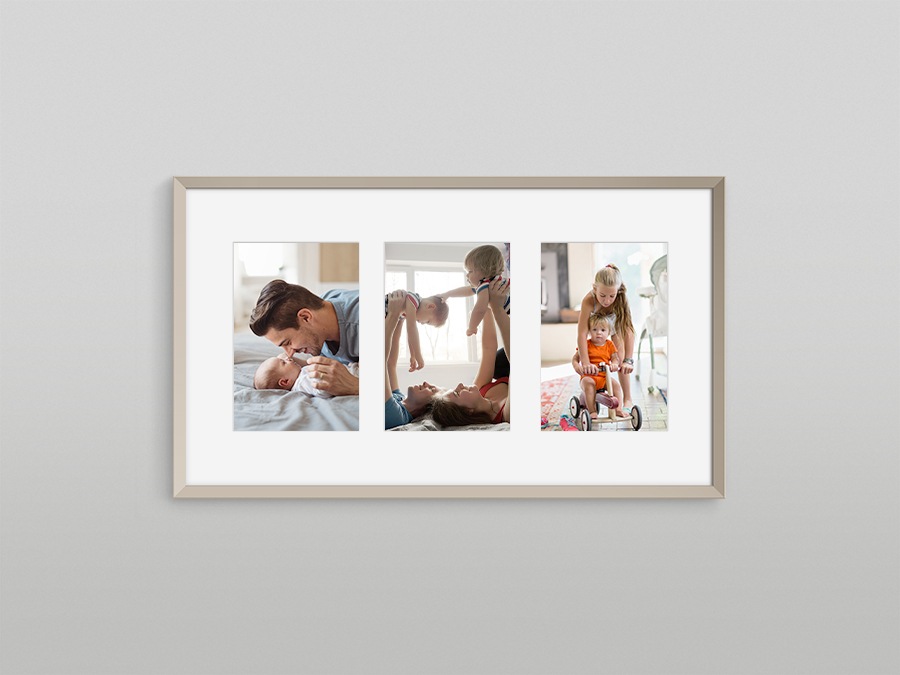 The Frame is hanging on a wall displaying 3 different types of pictures with a white matte background.
