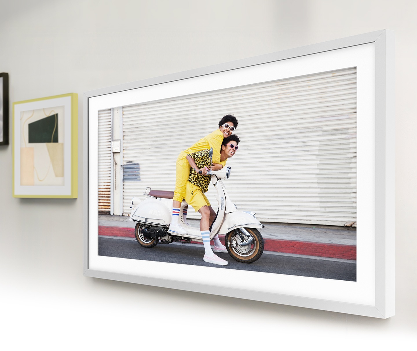 The Frame is hanging on the wall along with other picture frames, which makes The Frame look like a photo on the wall.