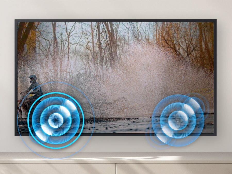 A person on a motorcycle is zipping past from one side to another. Built-in speakers follow the sound of the motorcycle as it moves.