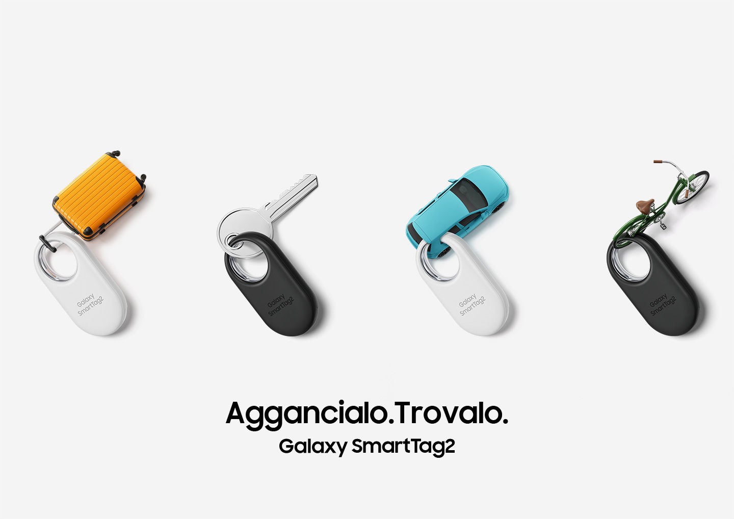 Four Galaxy SmartTag2 devices, two in white and two in black, are neatly placed. The devices are tagged to the following items: A miniature suitcase, a key, a miniature car, and a miniature bicycle.