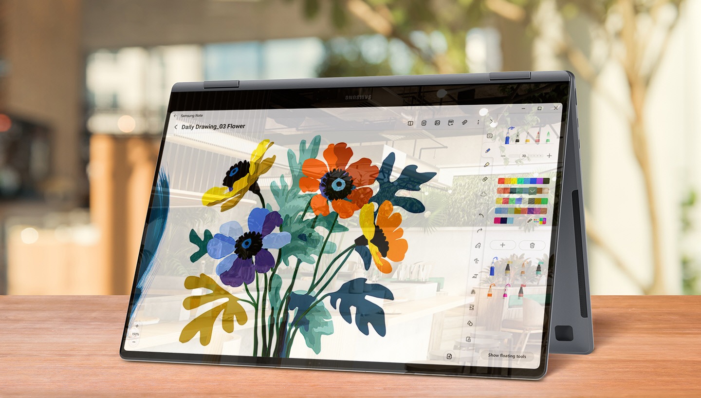 Galaxy Book4 Pro 360 is placed on a desk, folded like a tent and facing slightly left with a colorful image open for editing in Samsung Notes app onscreen. There are some reflections and glare on the onscreen image.
