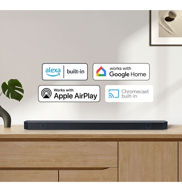 A Samsung Soundbar with logos for Alexa built-in, Works with Google Home, Works with Apple AirPlay and Chromecast built-in.