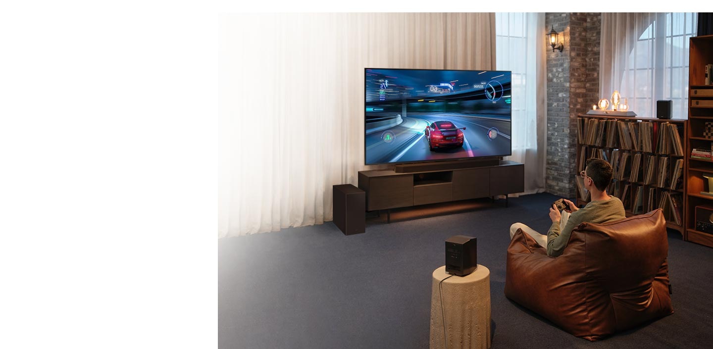 A man enjoys an immersive 3D-like gaming experience with Samsung Soundbar Game Mode Pro.