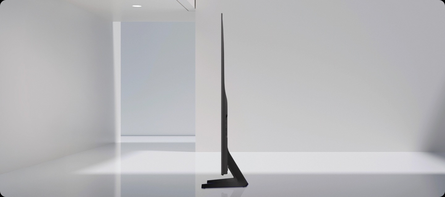 A side view of a slim TV with a subtly flowing silhouette. A ray of light goes down the side of the TV before it swivels to reveal its front side. A ray of light highlights the slim contour design of the TV once more.