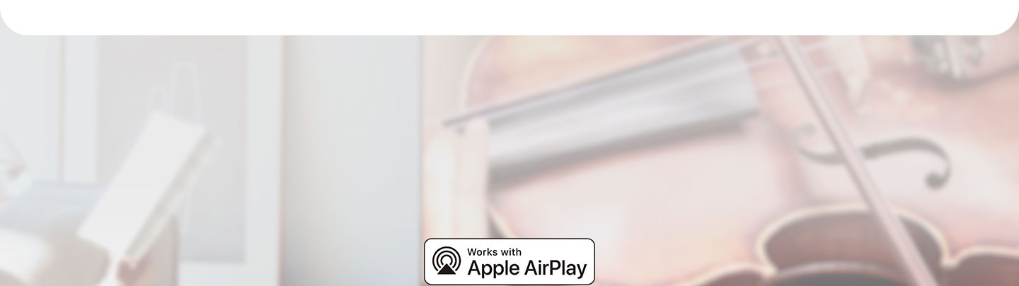 Works with Apple AirPlay logo against living room setting.