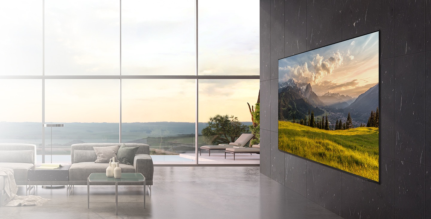 A TV hangs flush against the wall like a work of art in a modern living room, displaying an image of a meadow.