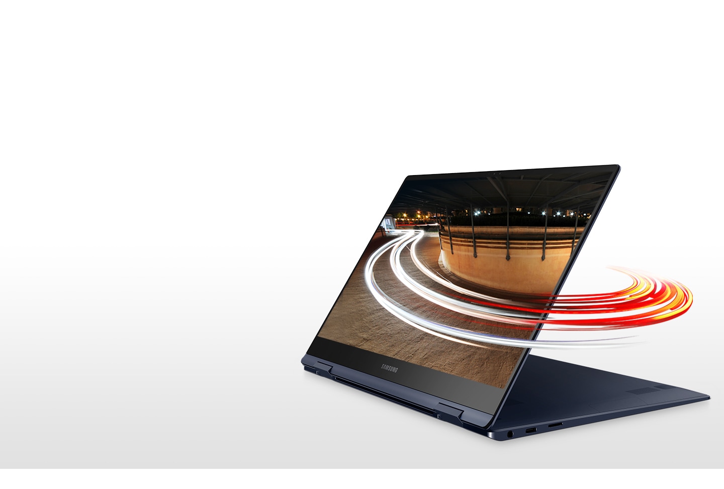 Laptop set like a tablet in a folio stand has light swirls encircling its screen, signifying the fast connectivity enabled by the Galaxy Book Pro 360.