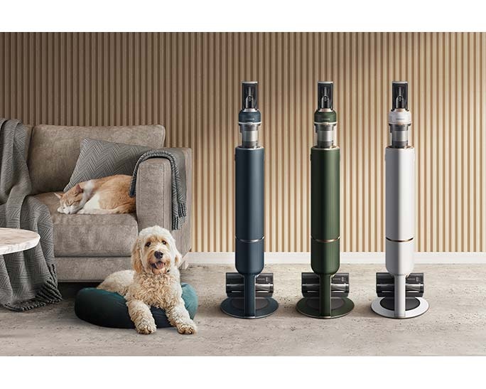 3 Samsung Bespoke Jet models in blue, green, and white stand upright next to a dog and a cat in a modern room.