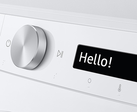 The AI washer’s control panel displays “Hello!”.