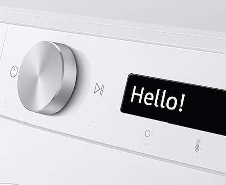 The AI washer’s control panel displays “Hello!”.
