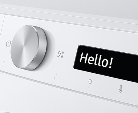 The AI washer's control panel displays “Hello!”