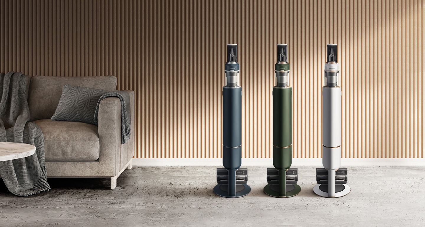 3 Samsung Bespoke JET models in blue, green, and white stand upright inside a modern room.