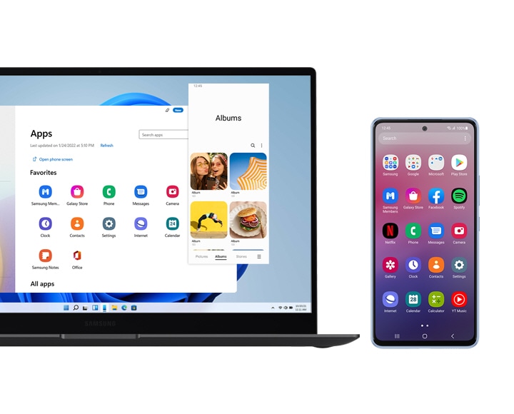 Una computadora portátil Galaxy y un teléfono inteligente Galaxy se muestran lado a lado. La computadora portátil muestra la ventana Apps (Aplicaciones), que muestra todas las aplicaciones descargadas en el teléfono inteligente. La aplicación Álbumes también se abre y muestra que el usuario podría acceder a la aplicación tal como lo haría en el teléfono inteligente. En la pantalla del smartphone inteligente, se muestra la pantalla de inicio, que muestra algunas de las aplicaciones que también se muestran en la pantalla de la computadora portátil. 