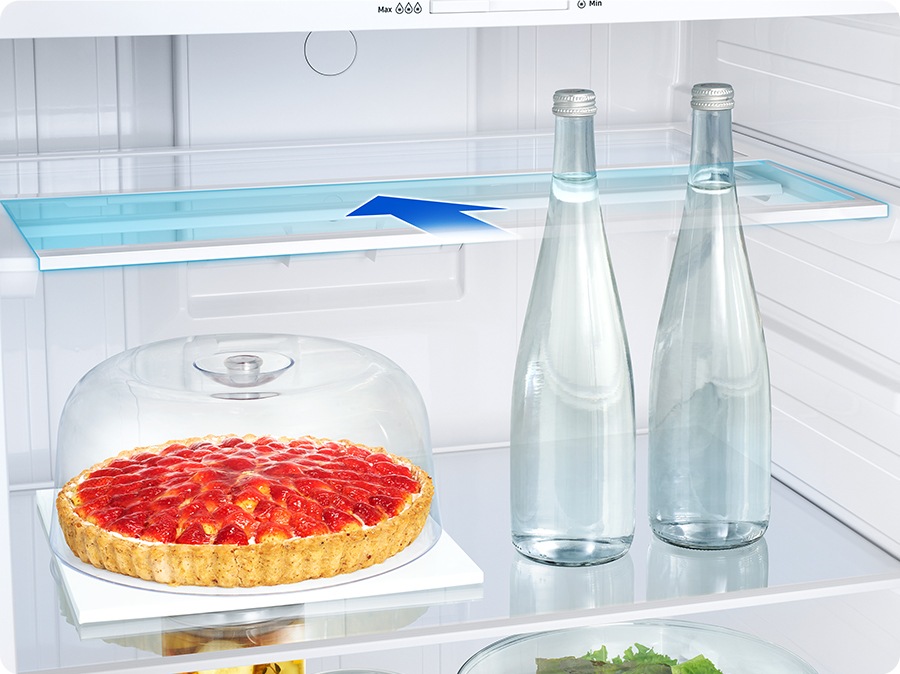 There are arrows to indicate that the shelf slides half its width into the refrigerator. So you can store not only pie also tall bottles on the shelf.