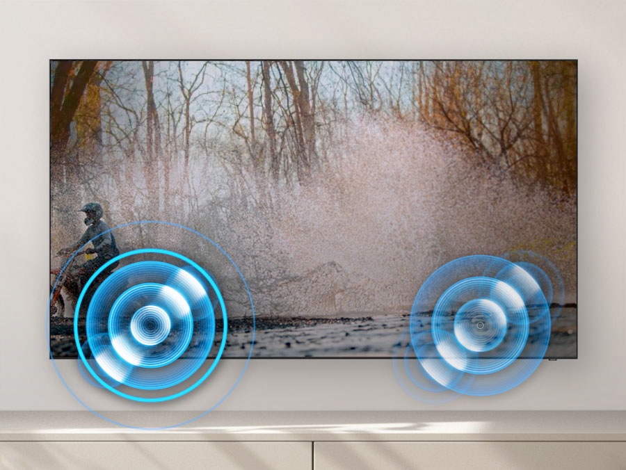 A person on a motorcycle speeds back and forth. Built-in speakers follow the sound of the motorcycle as it moves.