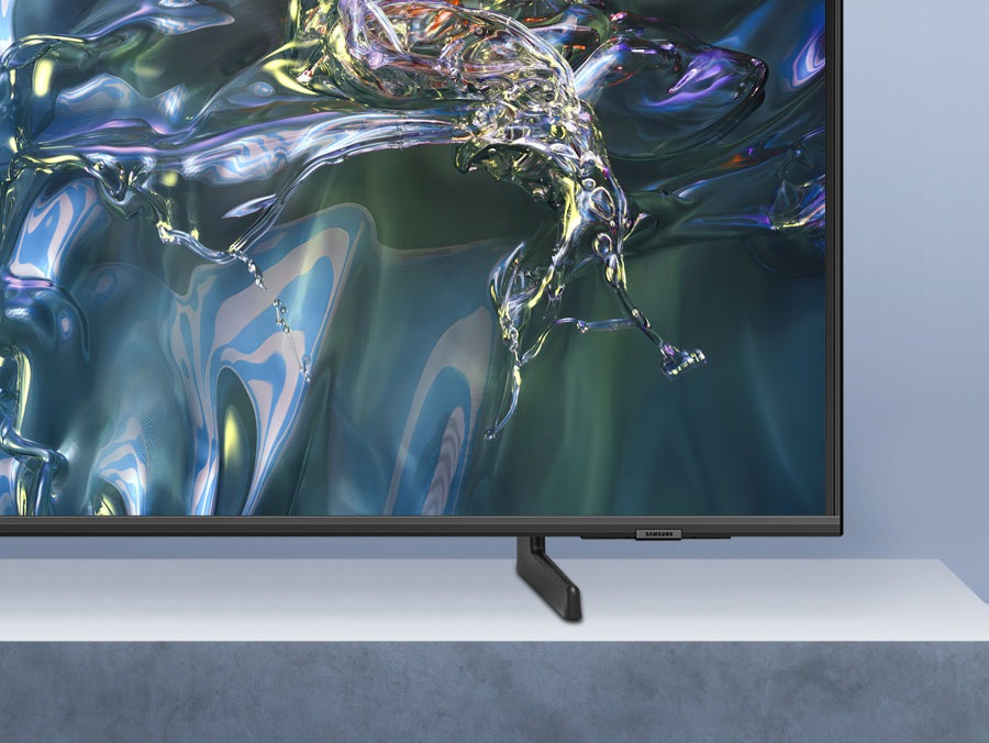 A QLED TV sits on an adjustable stand.