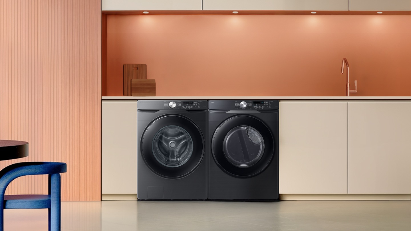 The washing machine is installed with a dryer in a modern and minimalist laundry room.