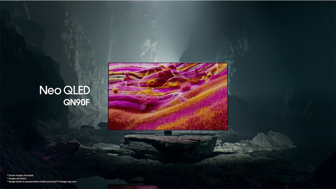 Samsung Neo QLED QN90F TV in a black and white underground space displays a colorful scene of an otherworldly landscape.