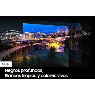 Se exhibe una ciudad iluminada por luces brillantes. Los colores y las luces son vívidos, ya que las luces OLED se proyectan a través de la pantalla QD.