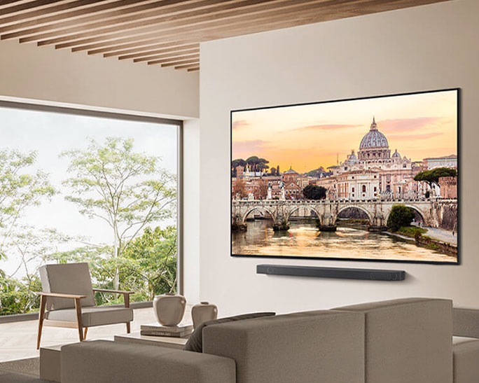 QN85D montado en la pared con barra de sonido en sala de estar natural.