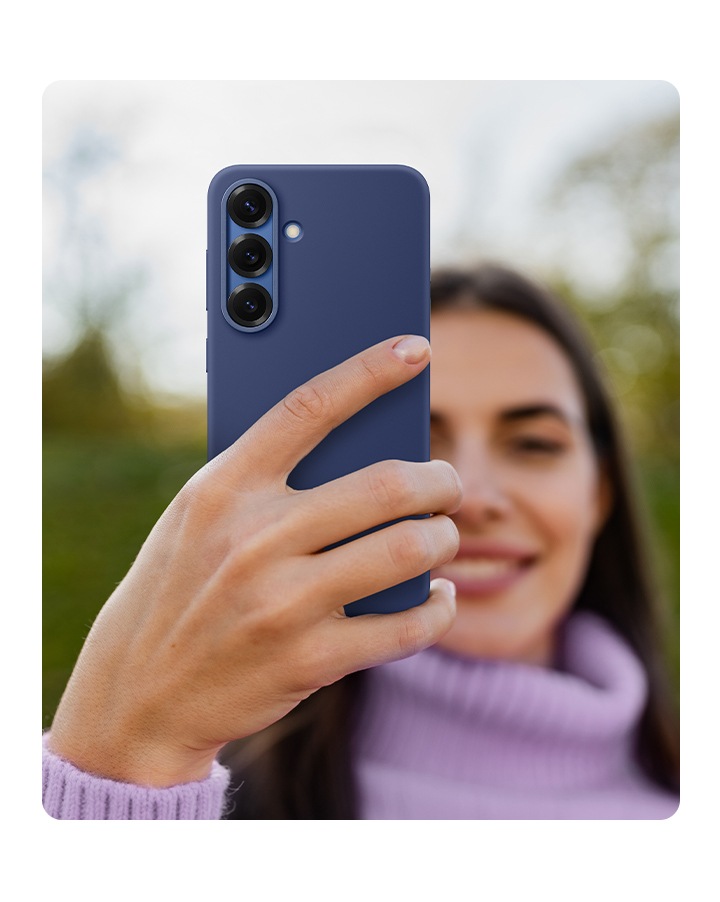 A person holds a Galaxy S25 installed with the Silicone Case in Blue.