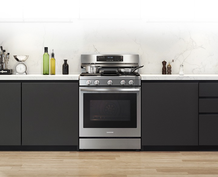 Shows a modern kitchen with the stylish, stainless steel oven fitting neatly into the design.