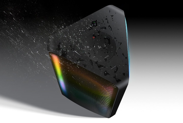 A Sound Tower is on display with water splashed over it to show it is water-resistant.