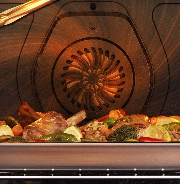 Shows the fan at the back of the oven circulating heated air all around the oven, so that it surrounds a tray of food.