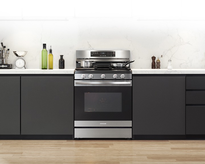 Shows a modern kitchen with the stylish, stainless steel oven fitting neatly into the design.