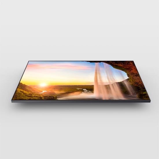 A QLED is displaying a man inside a snowy cave as well as a waterfall using the Dual LED backlight technology.