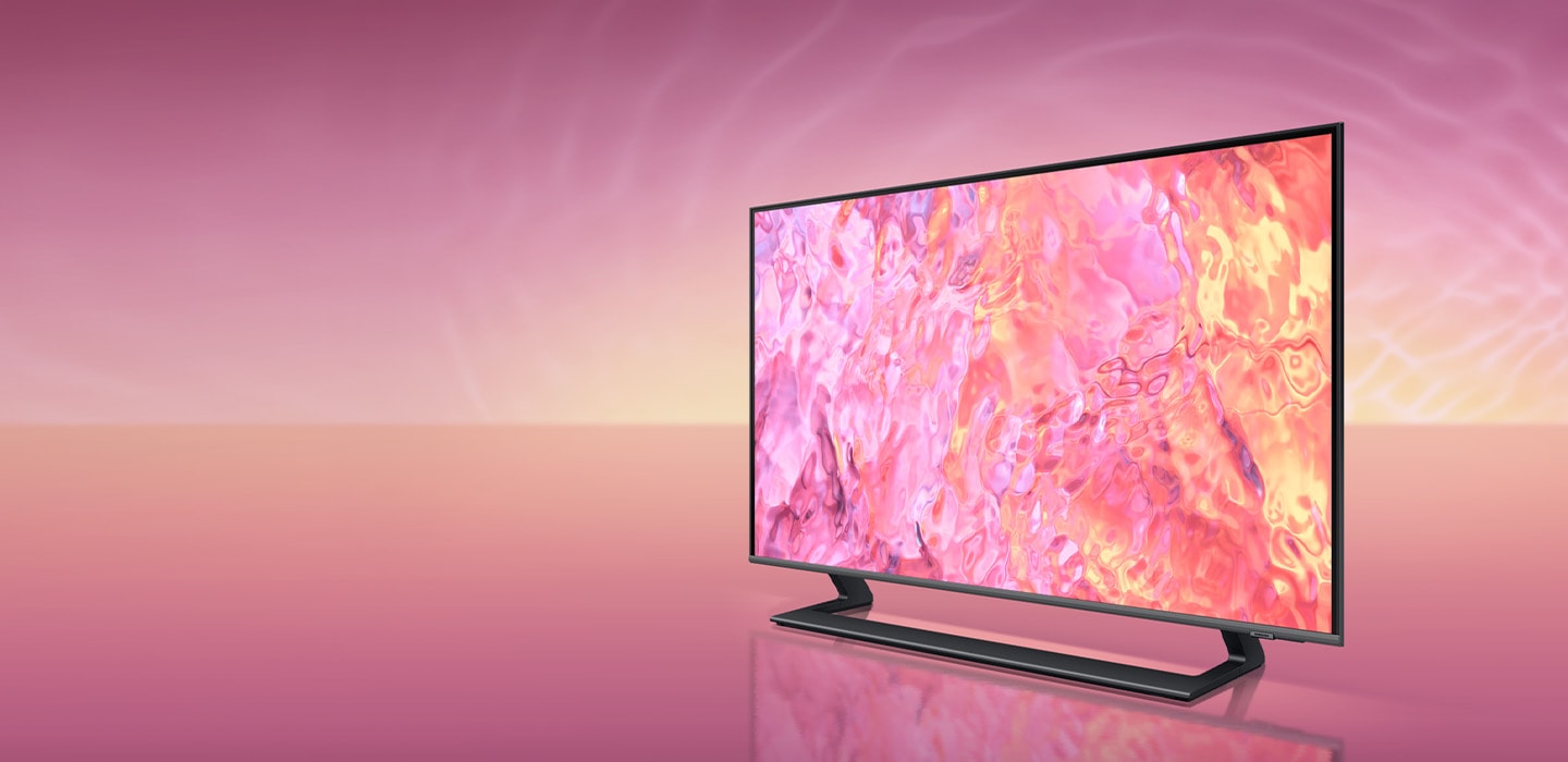 A QLED TV with a simple plus narrow stand is displaying pink graphic on its screen.