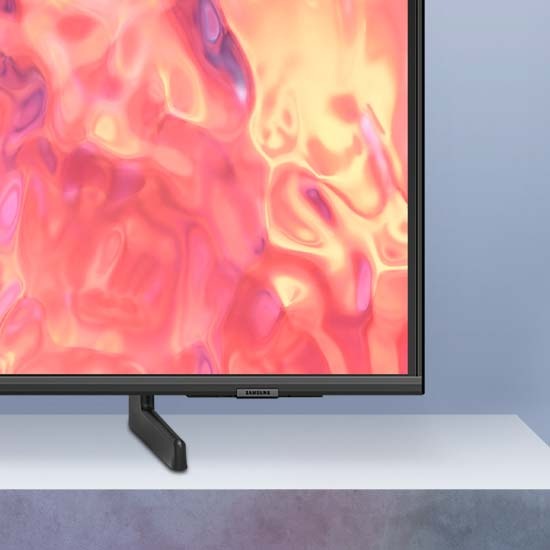 A QLED TV is placed on an Adjustable Stand.