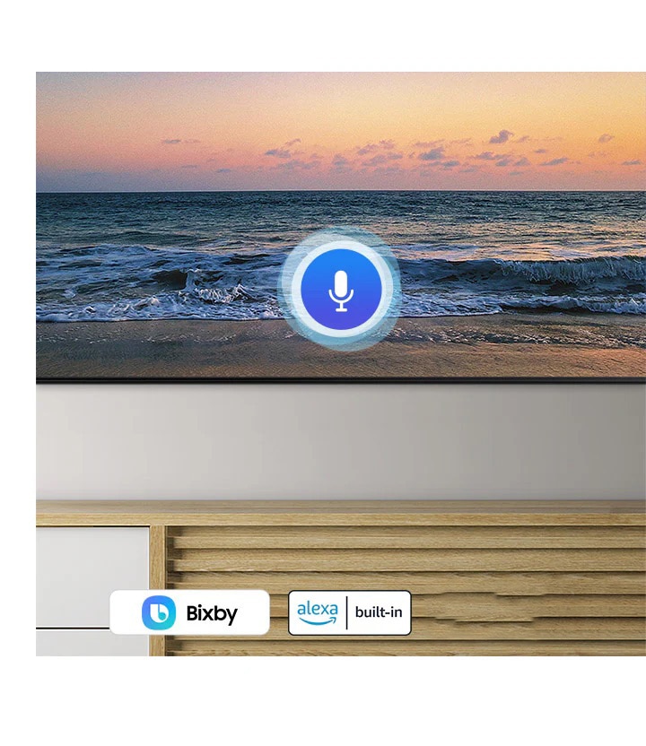 A microphone icon overlays a beach sunset TV screen image, demonstrating QLED TV voice assistant feature.