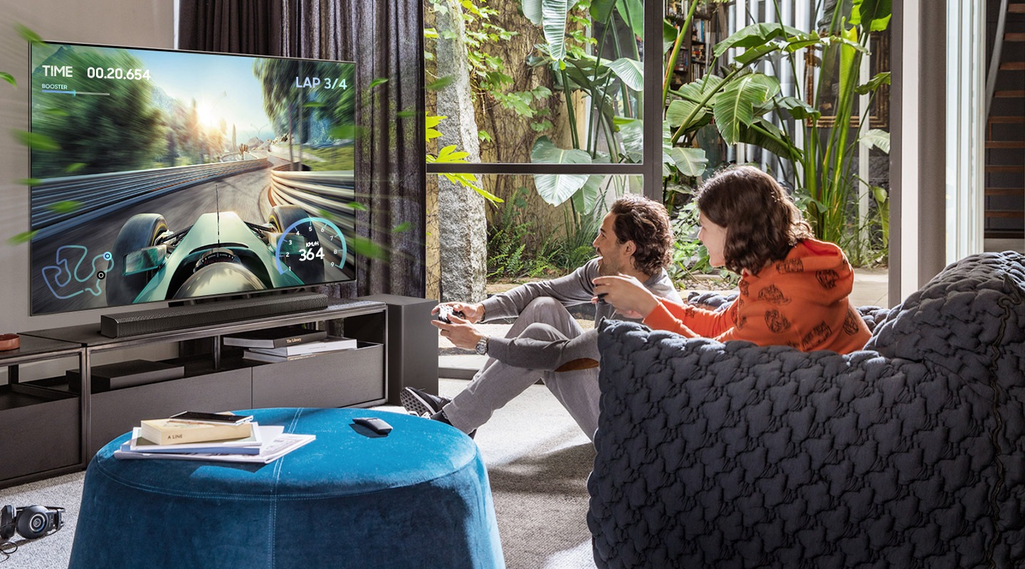 Two friends are enjoying an immersive gaming experience with Samsung Soundbar Game Mode Pro.