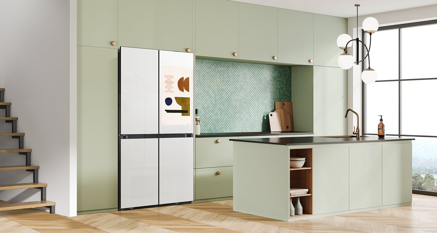 There is a french door Bespoke refrigerator in a sunlit contemporary kitchen with green cabinetry and a kitchen island.