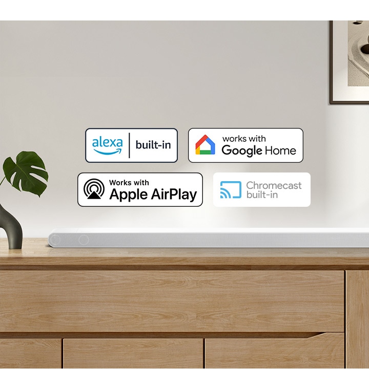 A Samsung Soundbar with logos for Alexa built-in, Works with Google Home, Works with Apple AirPlay and Chromecast built-in.