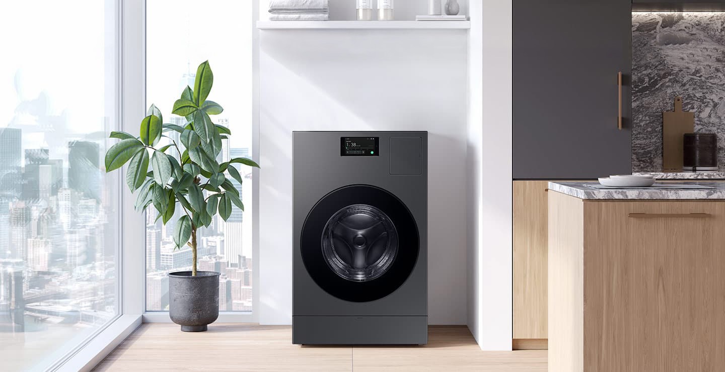 A washer-dryer All-in-one Combo is installed in a bright, sunlit apartment space next to a window.