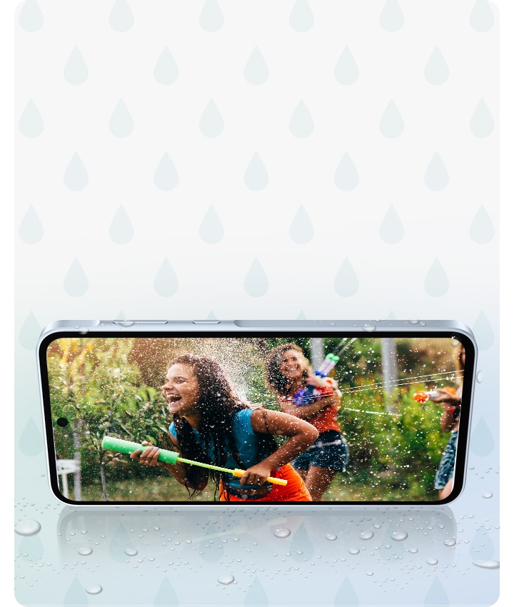 A smartphone in landscape mode displaying an image of two girls enjoying a water fight. There are water droplets around.