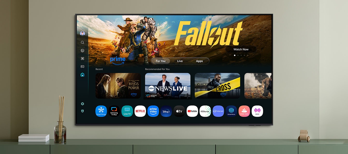 One UI Tizen’s home screen, with the various apps and services available, is displayed on a TV in a living room.